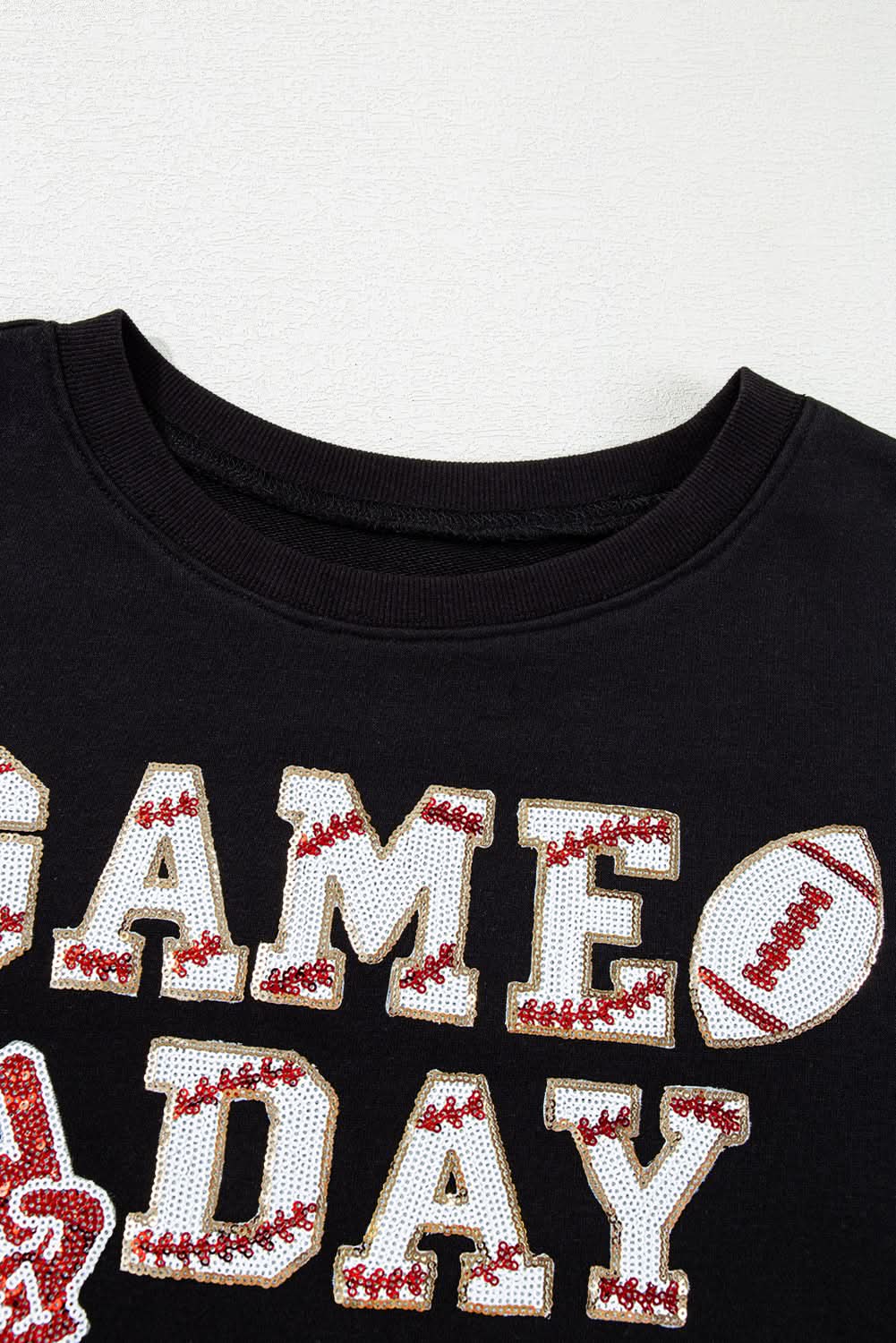 Black cropped rugby sweatshirt with tassels and sequins